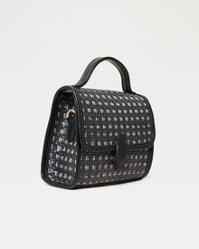 Side view of the Amelia Bag in black showing the woven texture and gold crossbody strap ring.