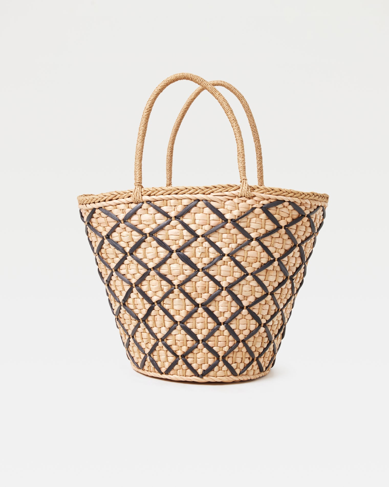Off-model front view of the Palma Nights Bag in natural-black, a large woven tote bag with a natural and black diamond lattice pattern and double rope handles, on a white background.