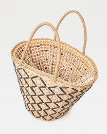 Angled top-down view of the Palma Nights Bag in natural-black showing the open interior and the natural-black lattice weave on the exterior.