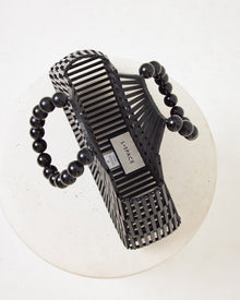 Top-down view of the Starlight Bag in black showing the interior with the LSPACE branding label and black beaded handles.