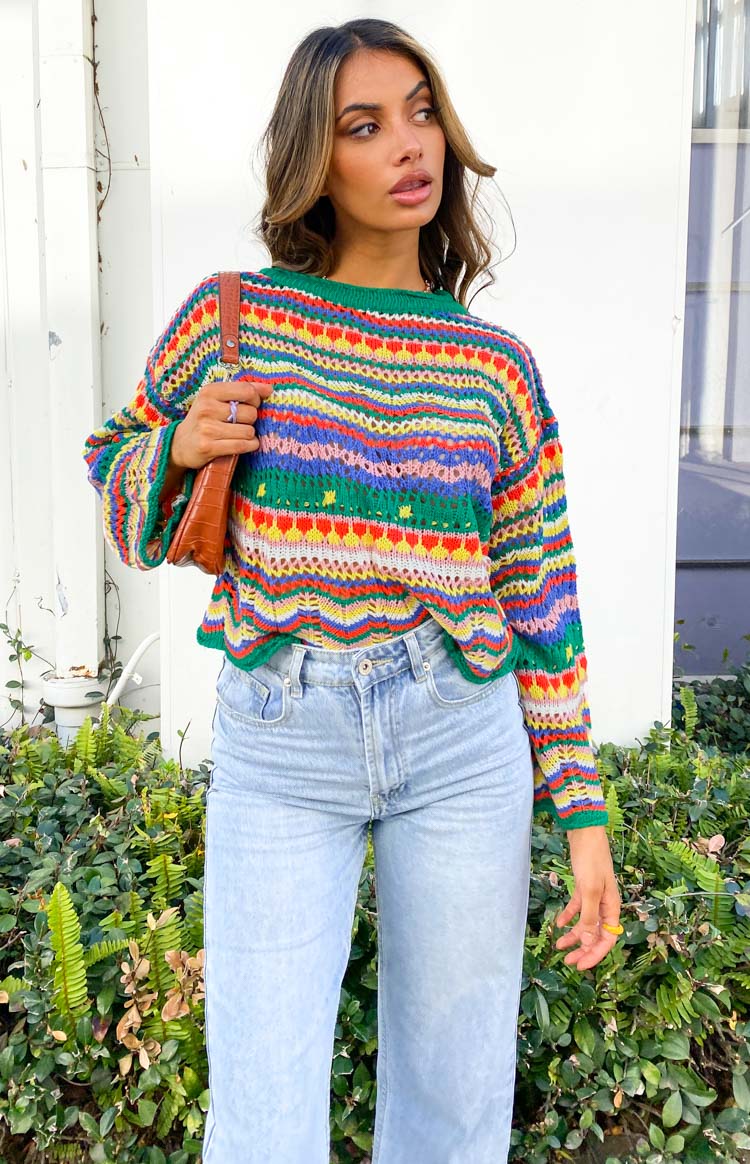 Multi-colour striped crochet knit sweater with green ribbed crew neck, long sleeves, and wavy hem