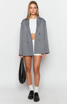 Front view of a grey pinstripe oversized blazer with notched lapels and double-breasted button closure