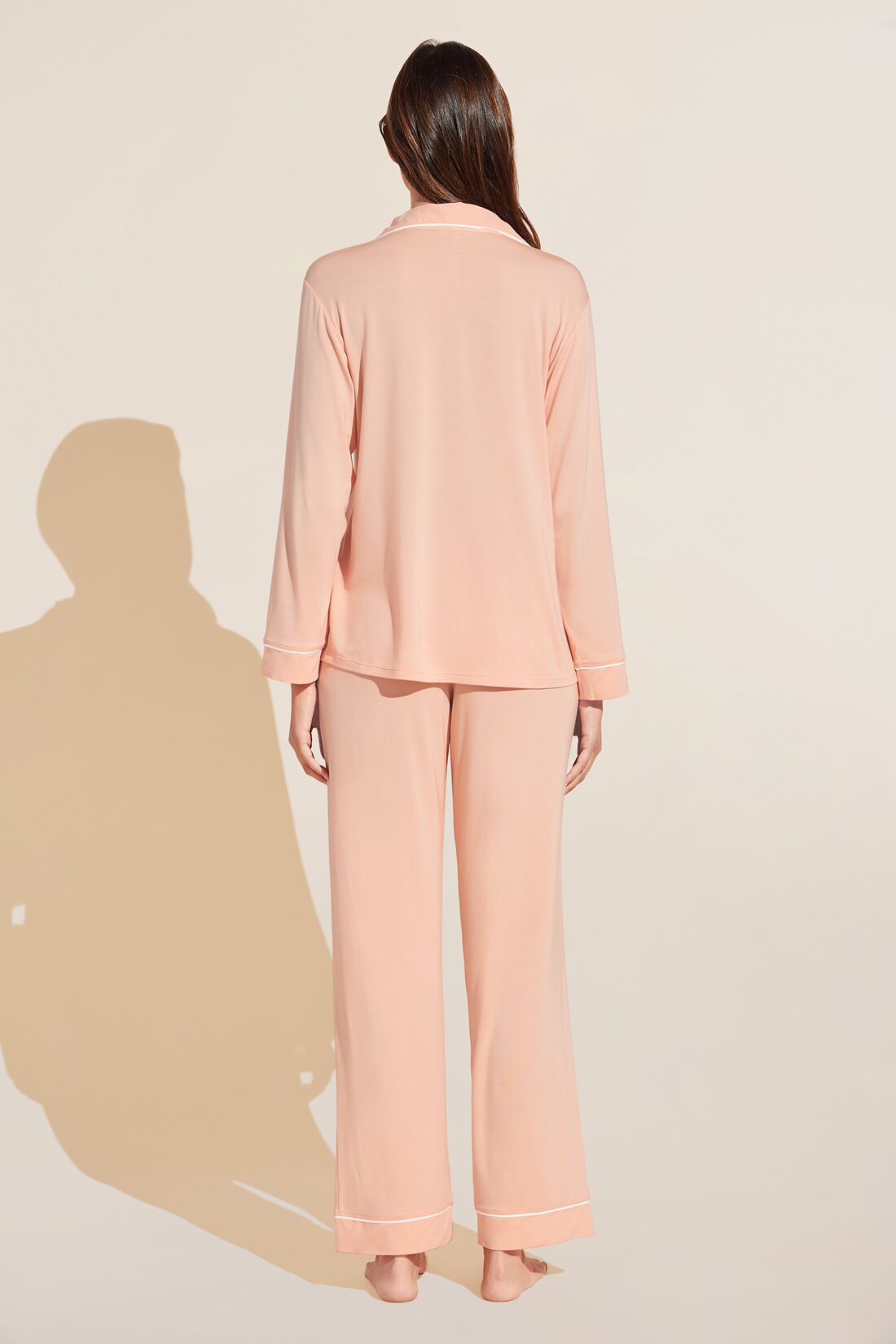 Model is Wearing the Gisele TENCEL Modal Long PJ Set in Peach Parfait/Ivory.