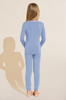 Model wears Kids TENCEL Modal Unisex Long PJ Set in Wedgewood Blue/Ivory.