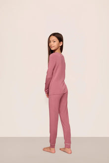 Model is wearing Kids TENCEL Modal Unisex Long PJ Set  in  Berry Blush/Ivory