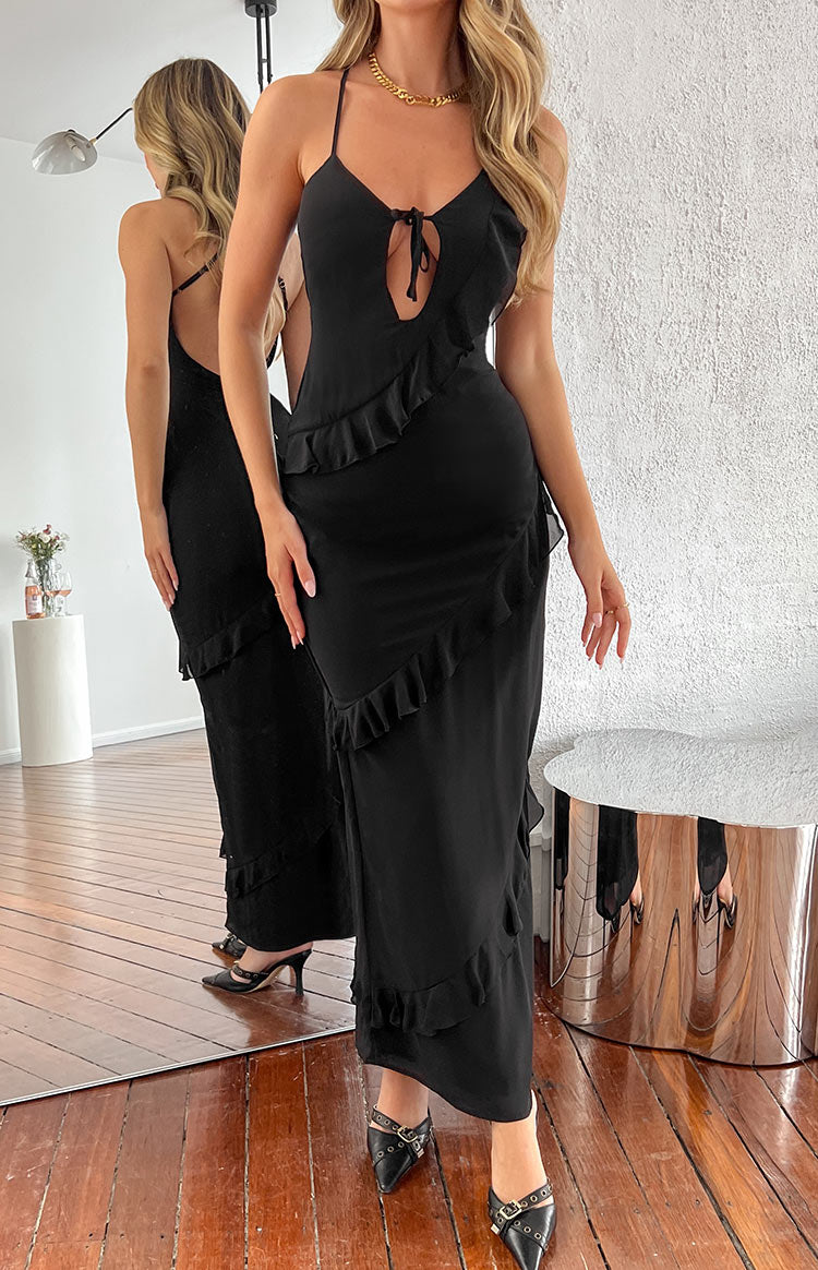 Rear view of a black chiffon maxi dress with a low scoop back, criss-cross adjustable straps, and tiered ruffles