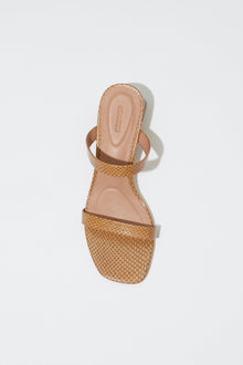 Tan leather slide sandal with debossed texture straps and block heel, shown from above.