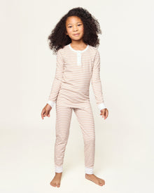 Kid's Pima Snug Fit Pajama Set in Camel Stripe features a beige and white striped long-sleeve top with white cuffs and button placket, plus matching pants with white ankle cuffs.