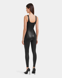 A woman wears the LAWREN - 8523047 Black vegan leather bodysuit by Rudsak.