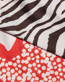 Close-up of fabric with zebra print and red pattern with white dots