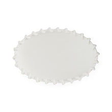 White scalloped-edge plate on a white background