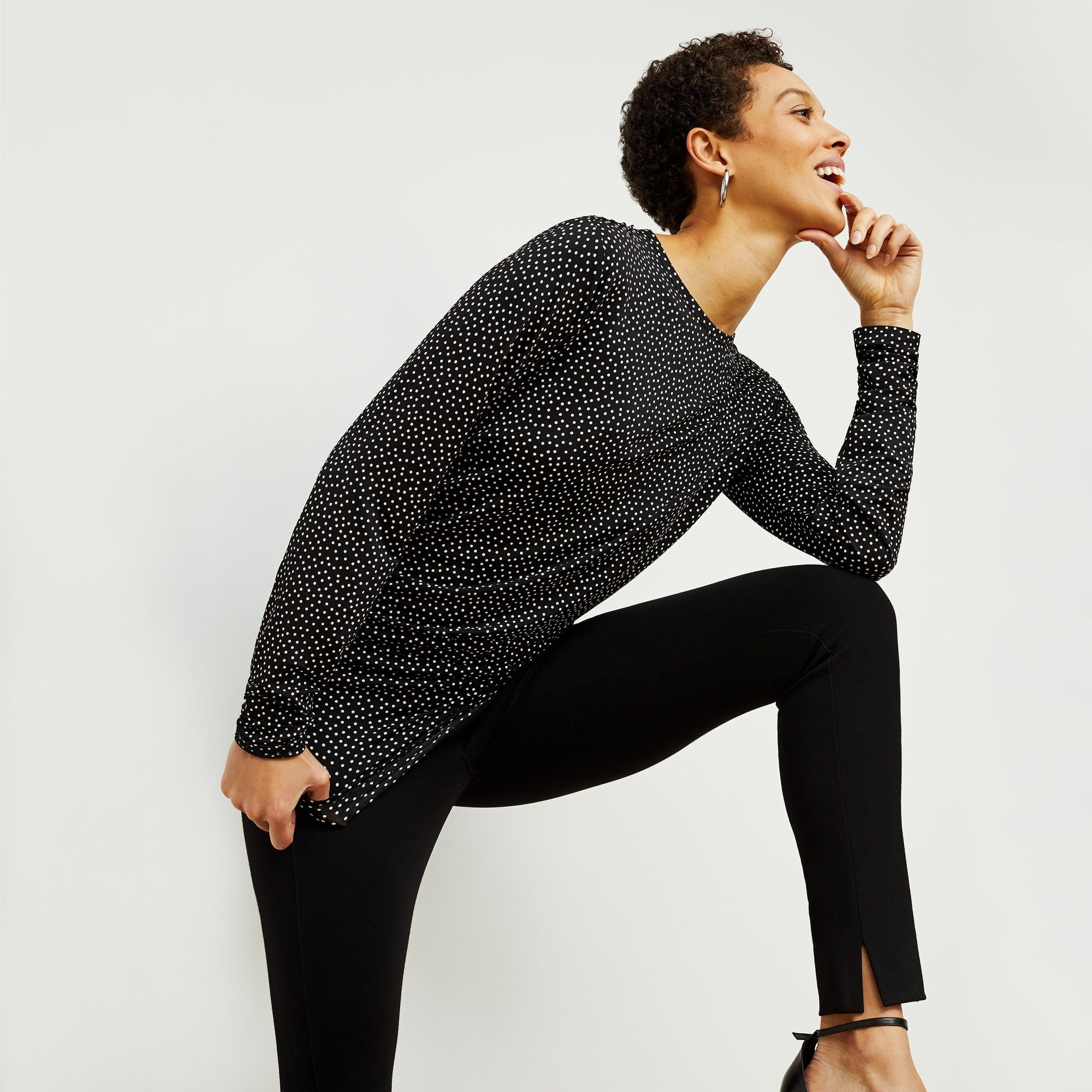 Side image of a woman standing wearing the stella legging in black | Exclude