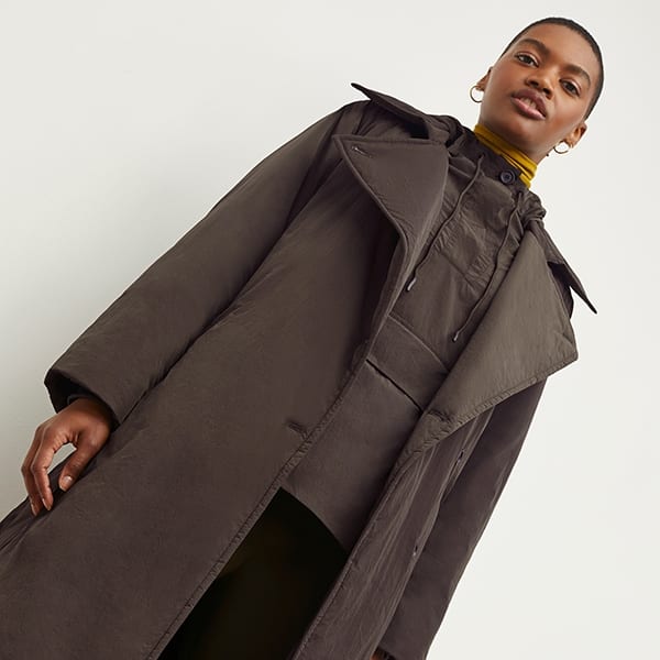 Front image of a woman standing wearing the Britt Hoodie—AirTech in Dark Moss | Exclude